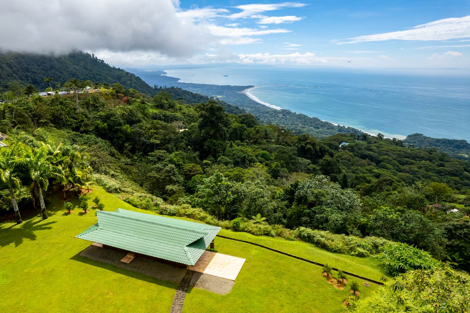 Vista Park at Costa Verde Estates — the open-air pavilion on its lawn, looking down the coast to the Whale’s Tail at Uvita