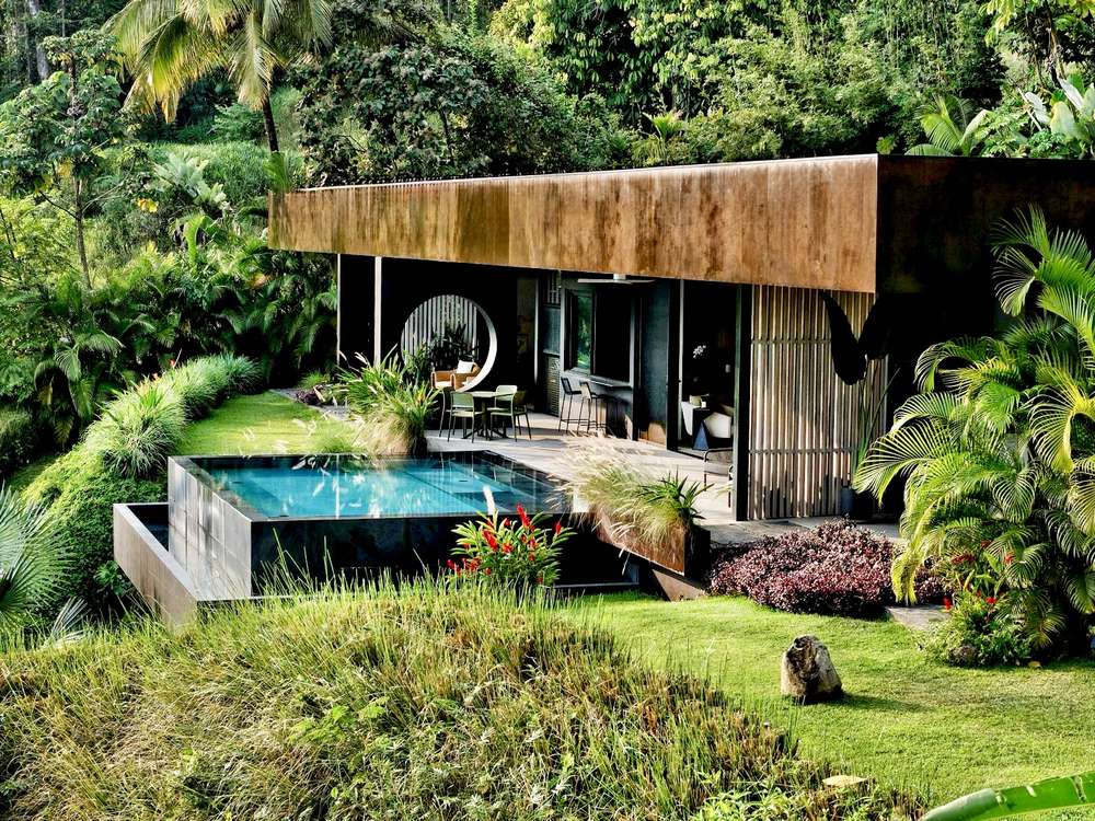 The villa, its pool, and the tropical planting that screens it