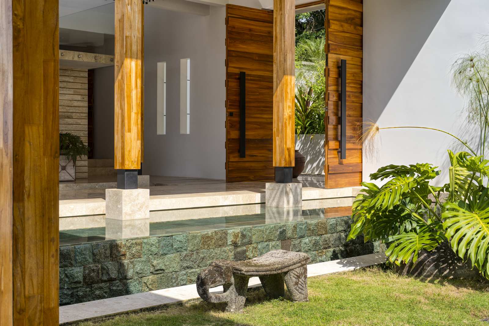 The double French-door entrance, crossing the water features