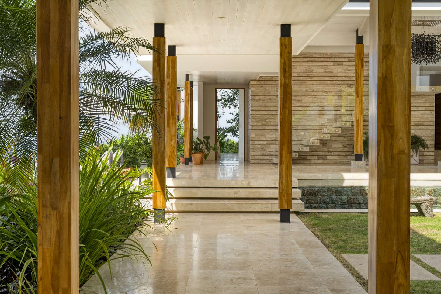 A travertine corridor running under the timber columns