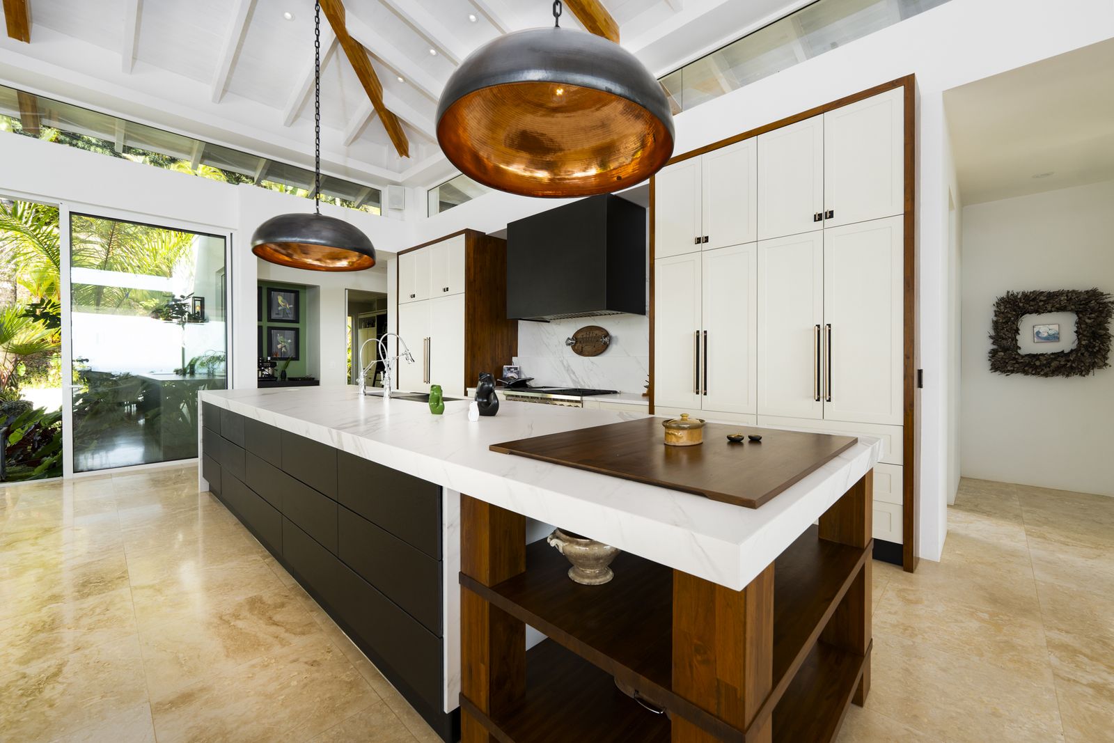 The kitchen and its copper pendants, open to the terrace