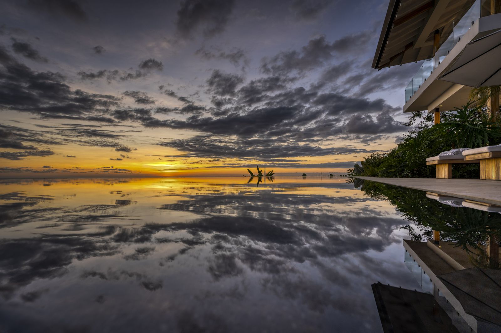 Sunset mirrored in the surface of the lap pool