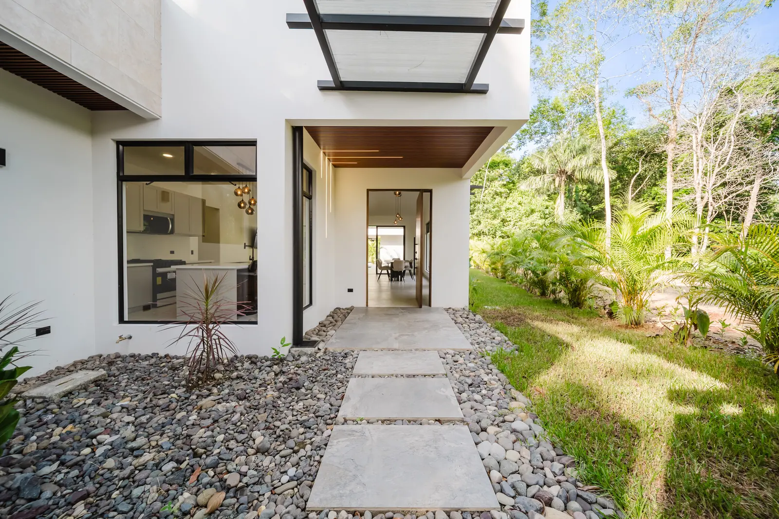 Casa Escondida &mdash; the entry path and the solid-wood pivot door