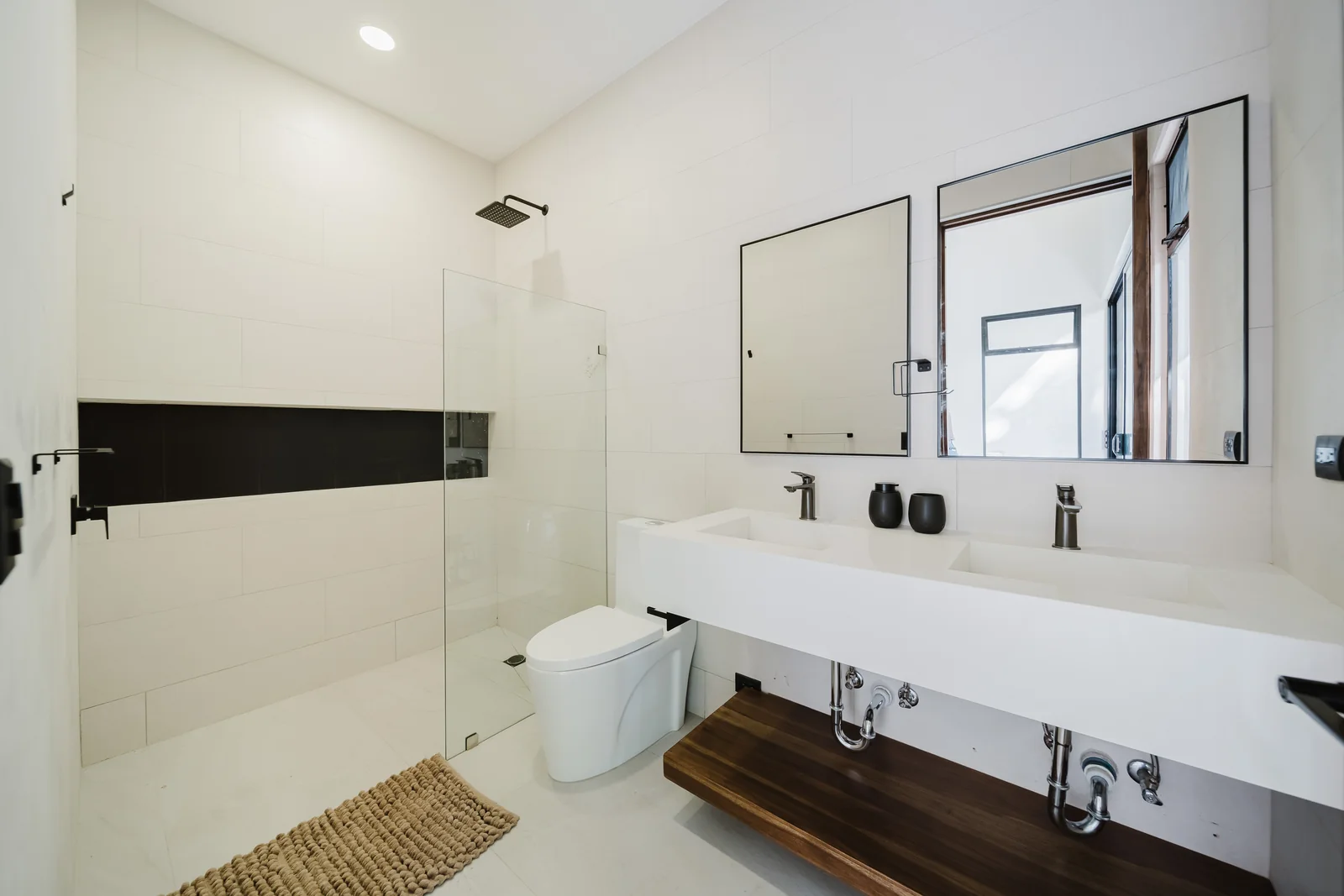 Casa Escondida &mdash; an en-suite bathroom with dual white quartz vanities