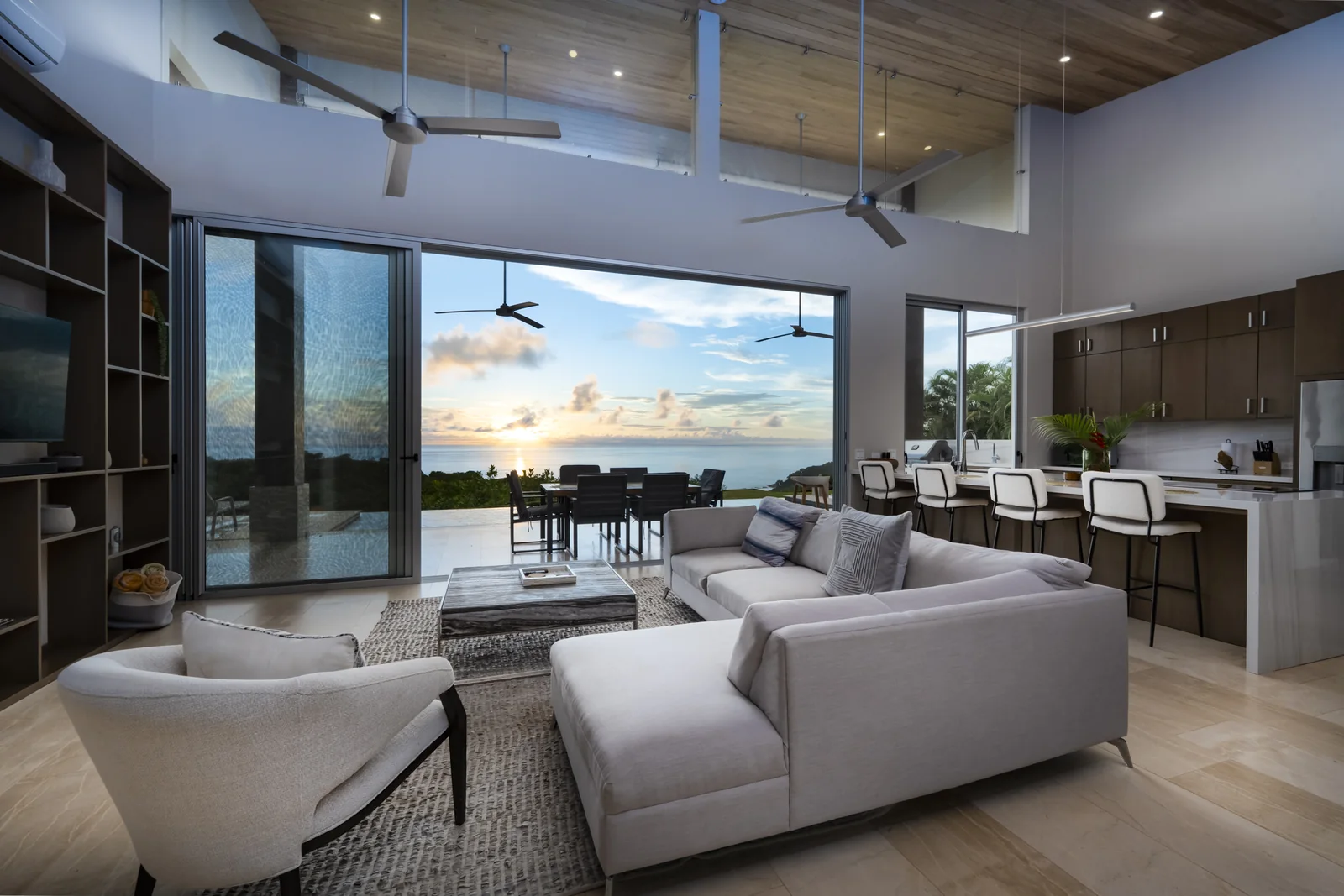 Casa Horizonte — the living room, opened to the terrace with the ocean beyond