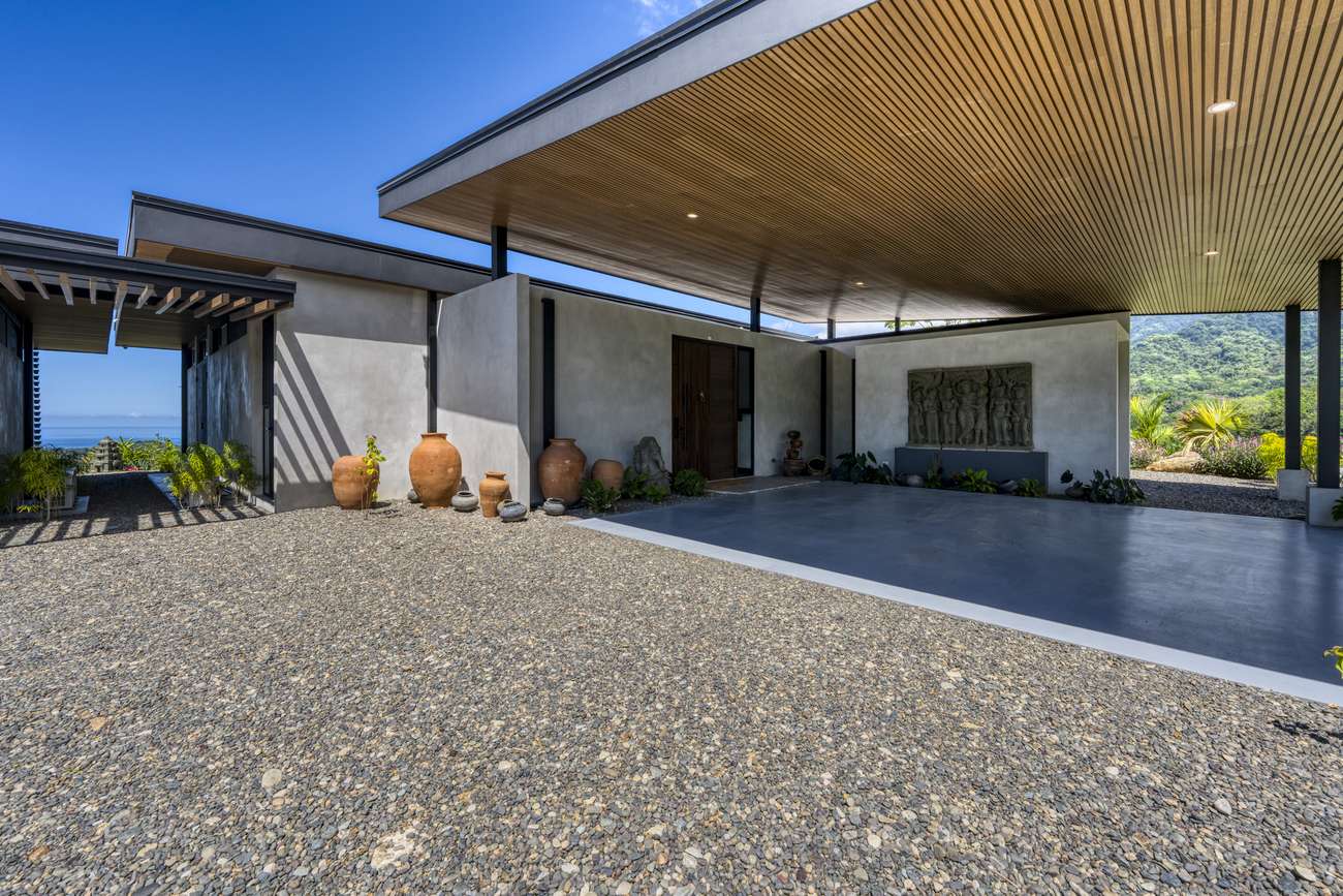 Casa Karuna &mdash; The covered terrace and parking, open to the pool beyond