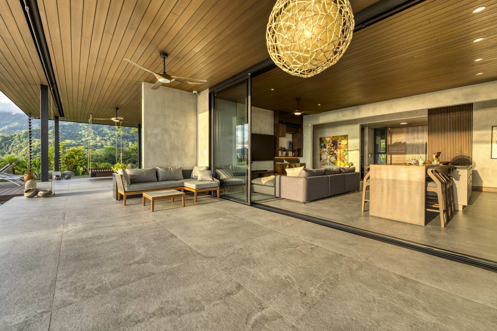 Casa Karuna &mdash; The living room, opening to the terrace through full-height glass