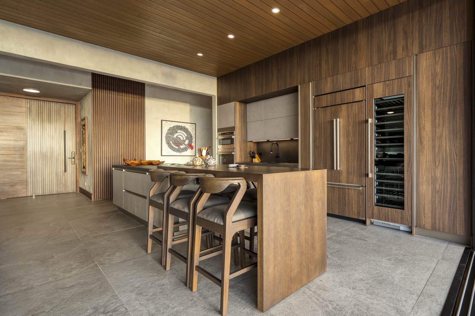 Casa Karuna &mdash; The kitchen island, with bar seating and wine storage