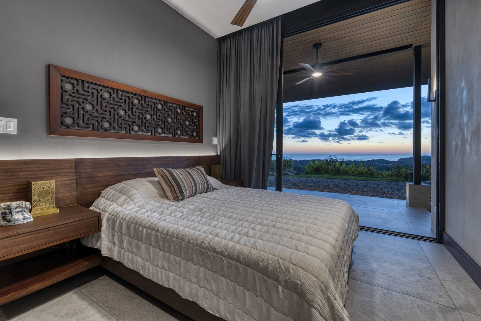 Casa Karuna &mdash; A bedroom facing the view through sliding glass