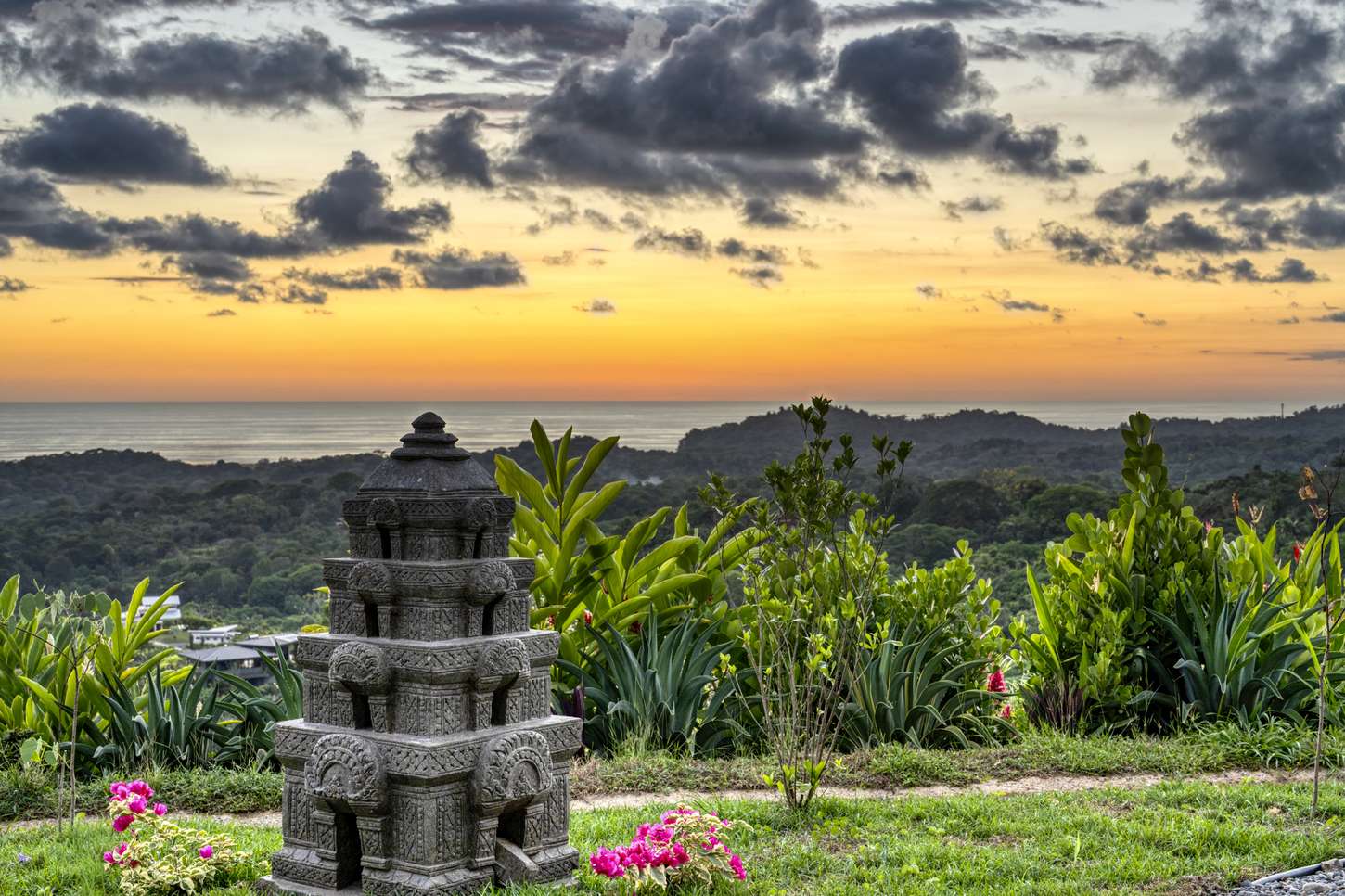 Casa Karuna &mdash; A carved stone stupa in the garden, the coast beyond
