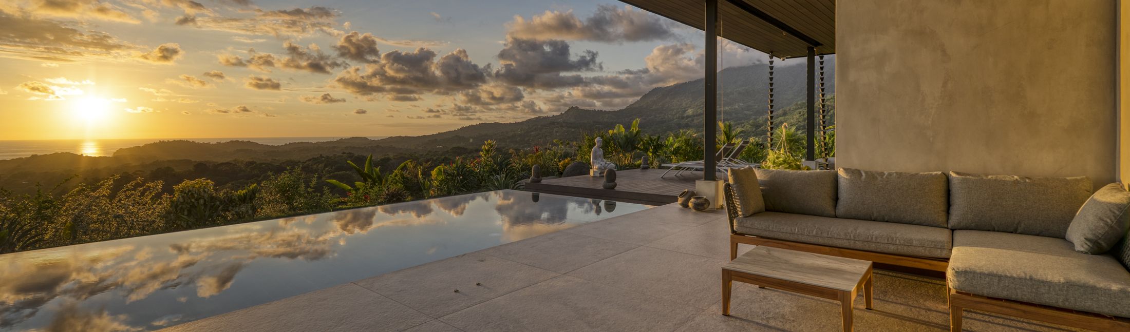 Casa Karuna at sunset, its infinity pool and terrace above the hills of Ojochal