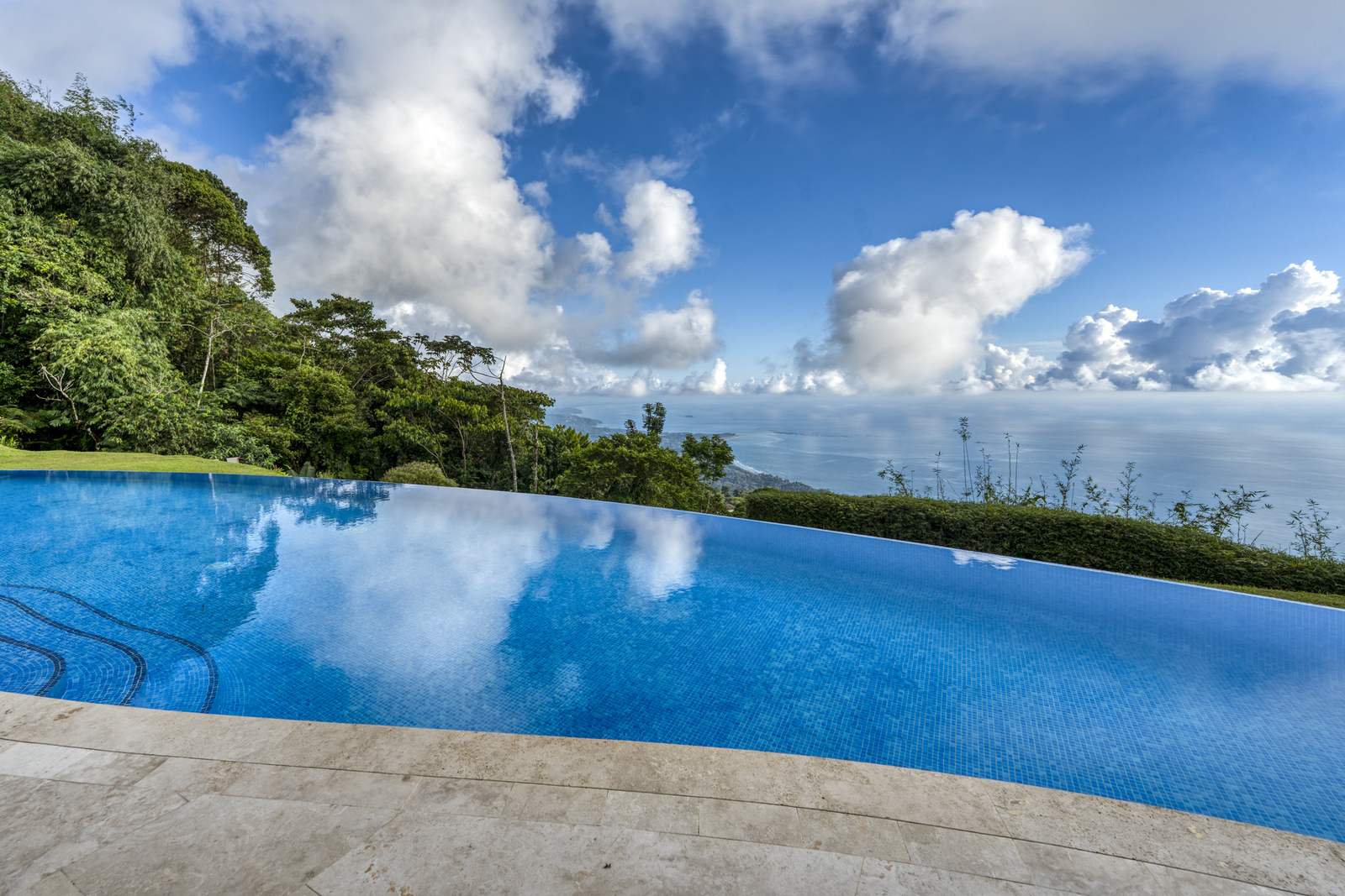 The infinity edge, where the pool reads as continuous with the Pacific