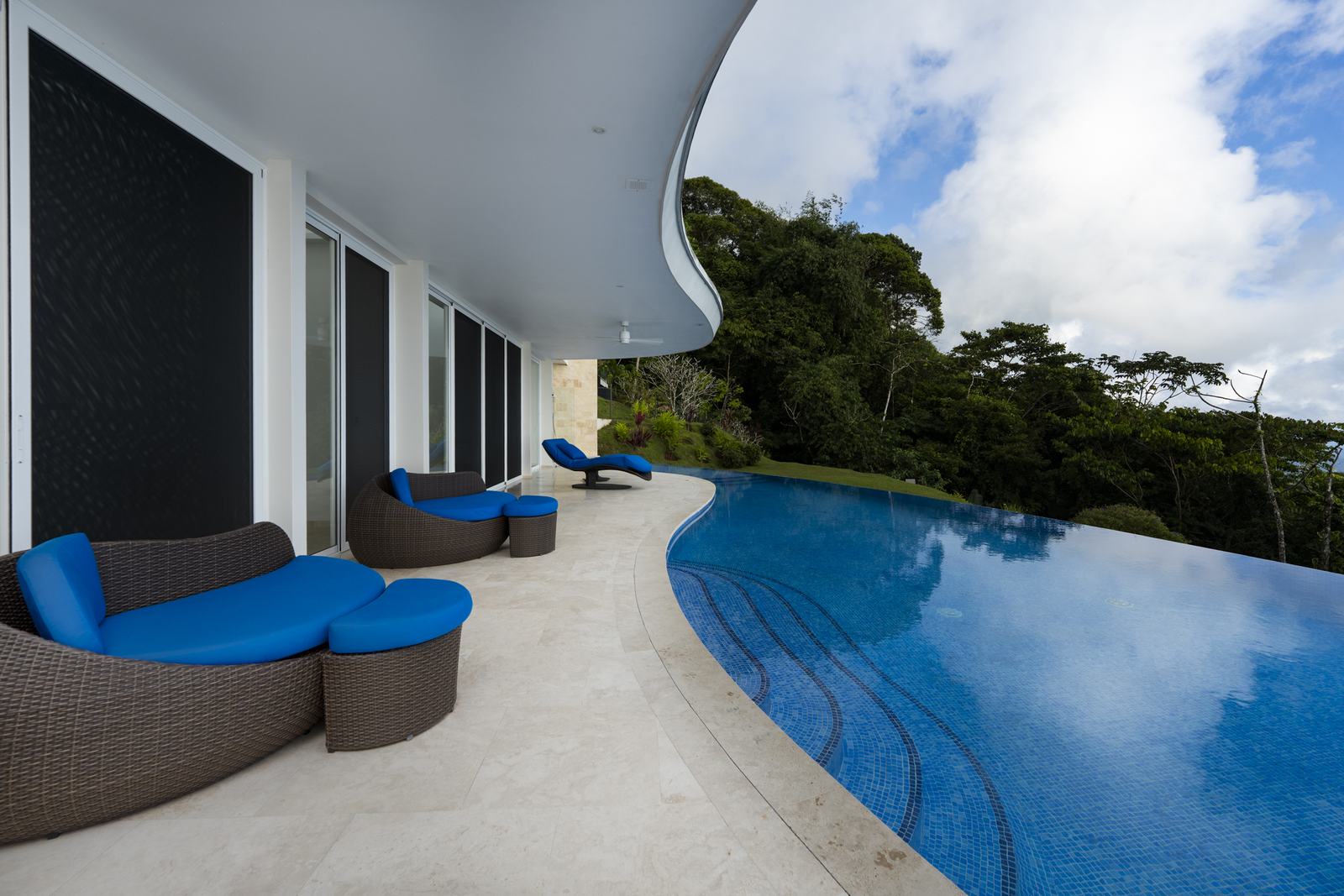 Loungers set under the terrace overhang beside the water