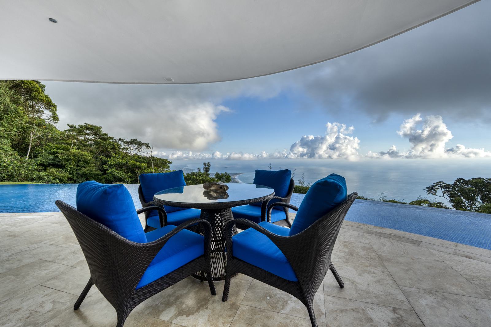 The terrace dining table, positioned above the pool and the view