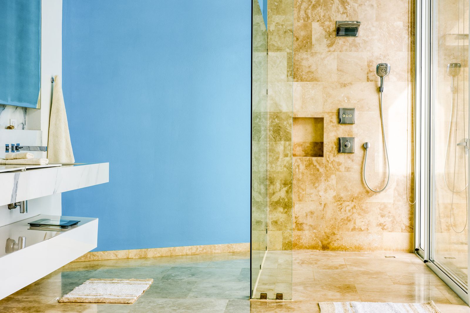 The shower, tiled in blue glass