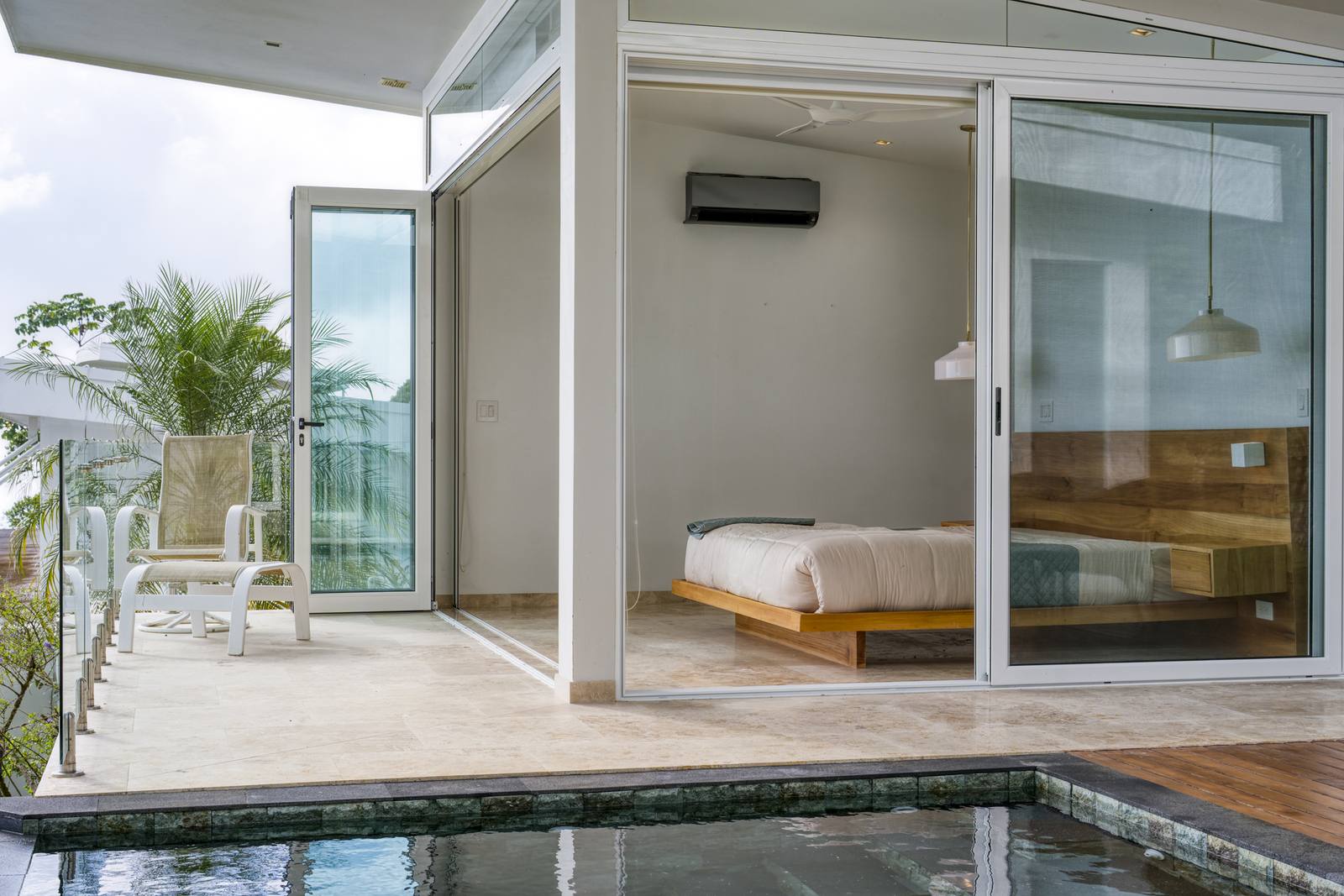 A bedroom in the detached guest house, beside its plunge pool