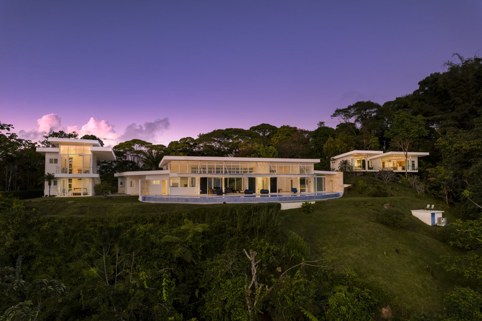 The ridge at dusk, with the house and its neighbors in Costa Verde Estates