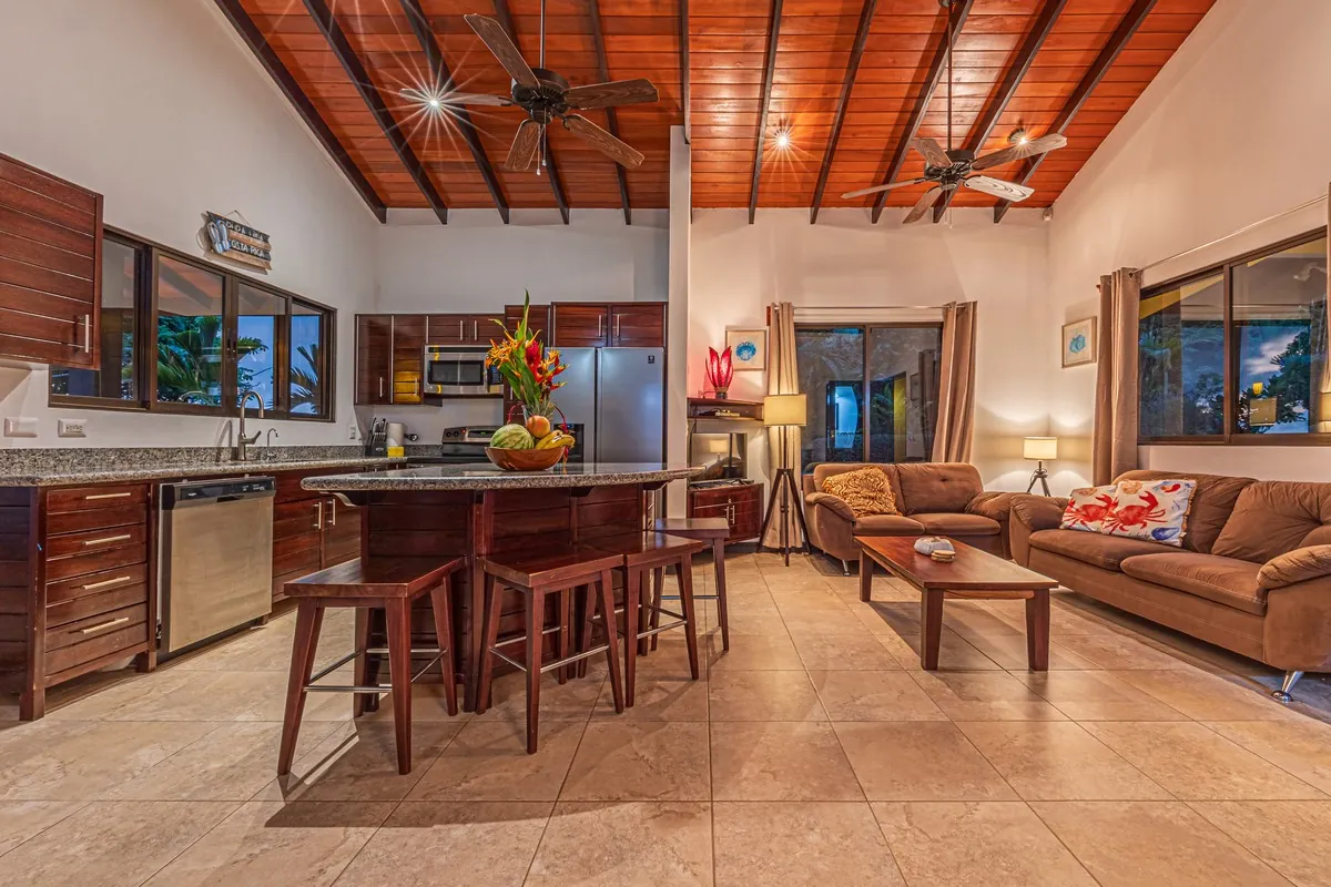 Casa Ola Azul &mdash; the living room and kitchen bar under the vaulted ceiling