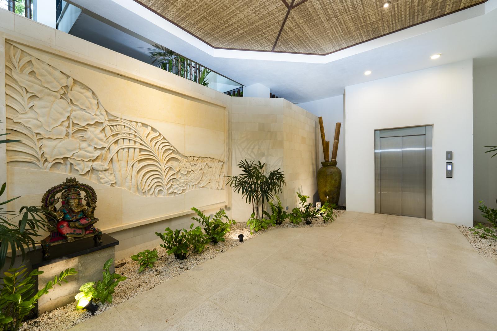 Casa SolAngelo &mdash; the three-story limestone carving beside the elevator