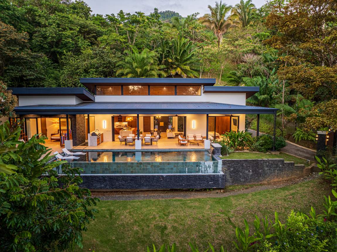 Casa Tango &mdash; The house lit at dusk, seen across the pool