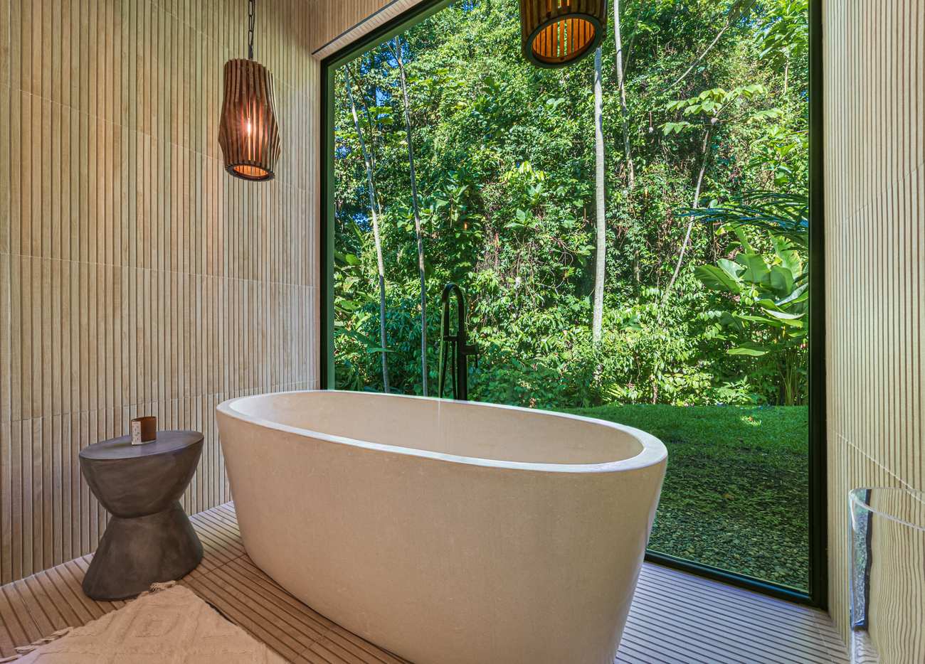 Casa Tango &mdash; A freestanding tub set against a wall of glass