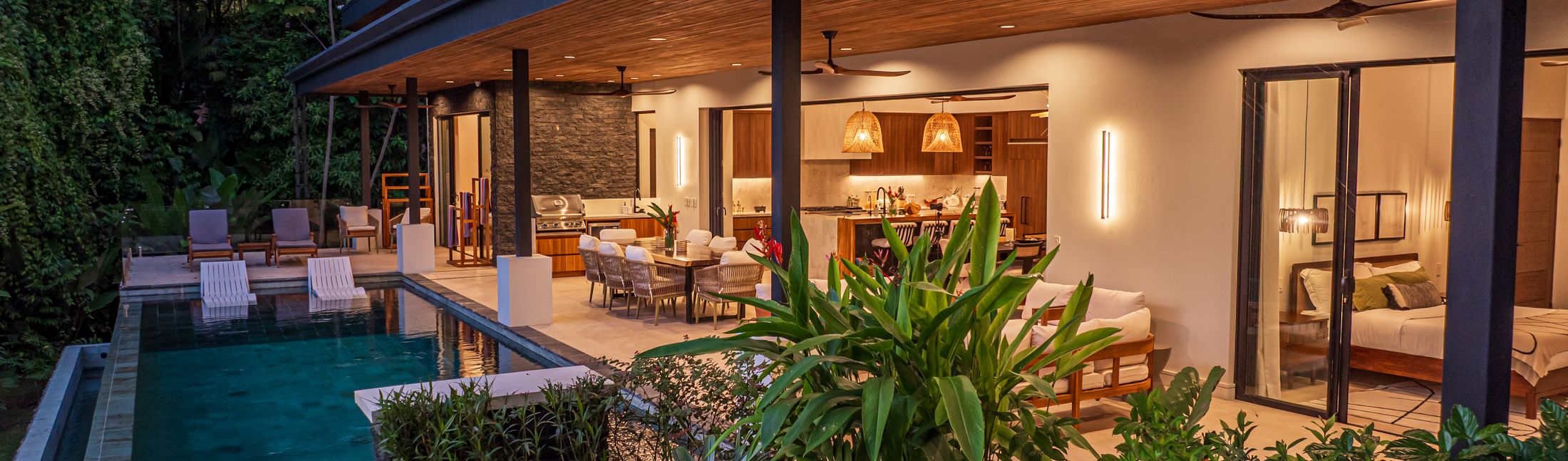 Casa Tango lit at dusk above its lap pool, in Las Colinas above Playa Hermosa