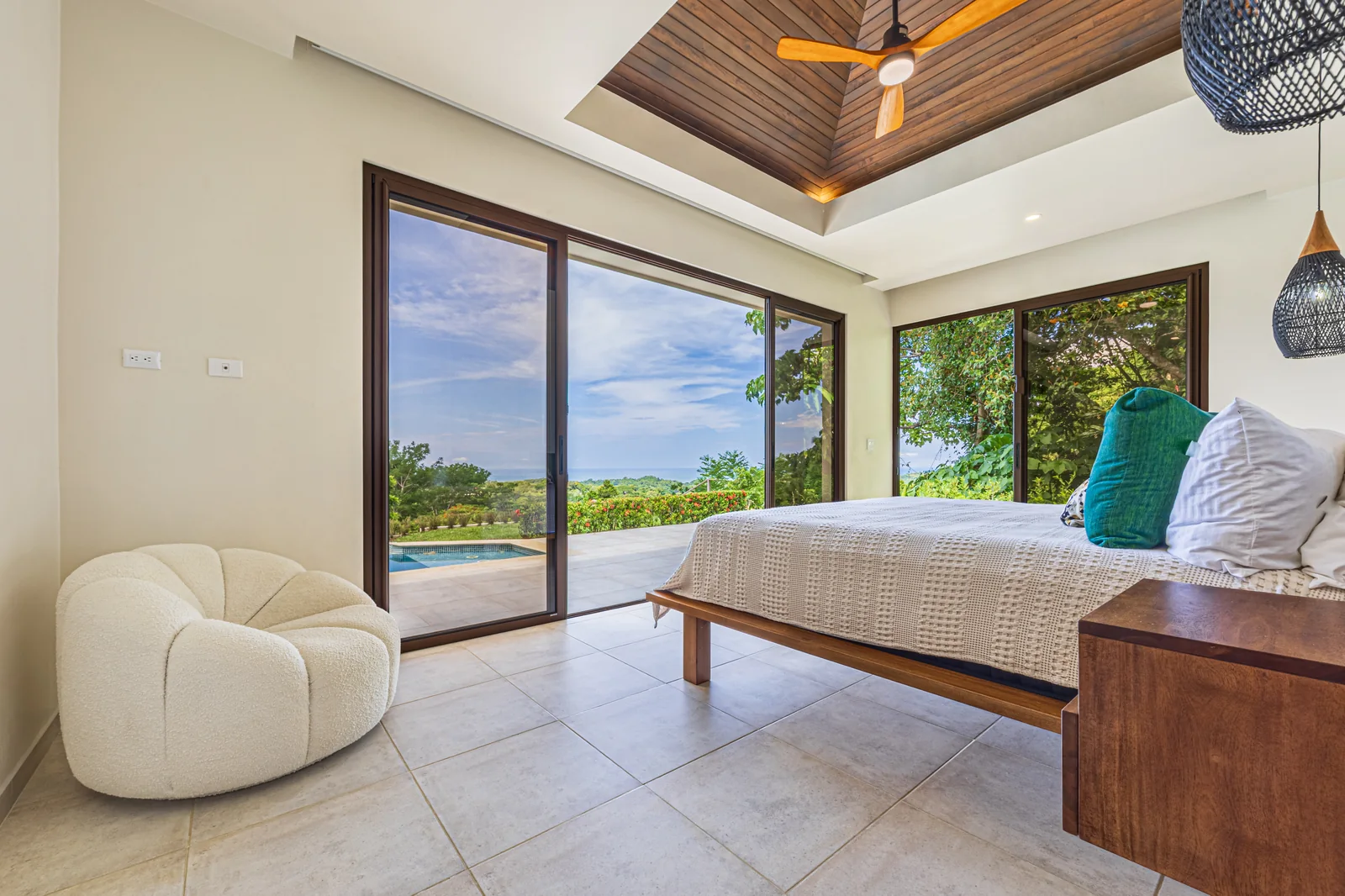 Casa Tranquilidad &mdash; the primary suite, glazed to the treetops