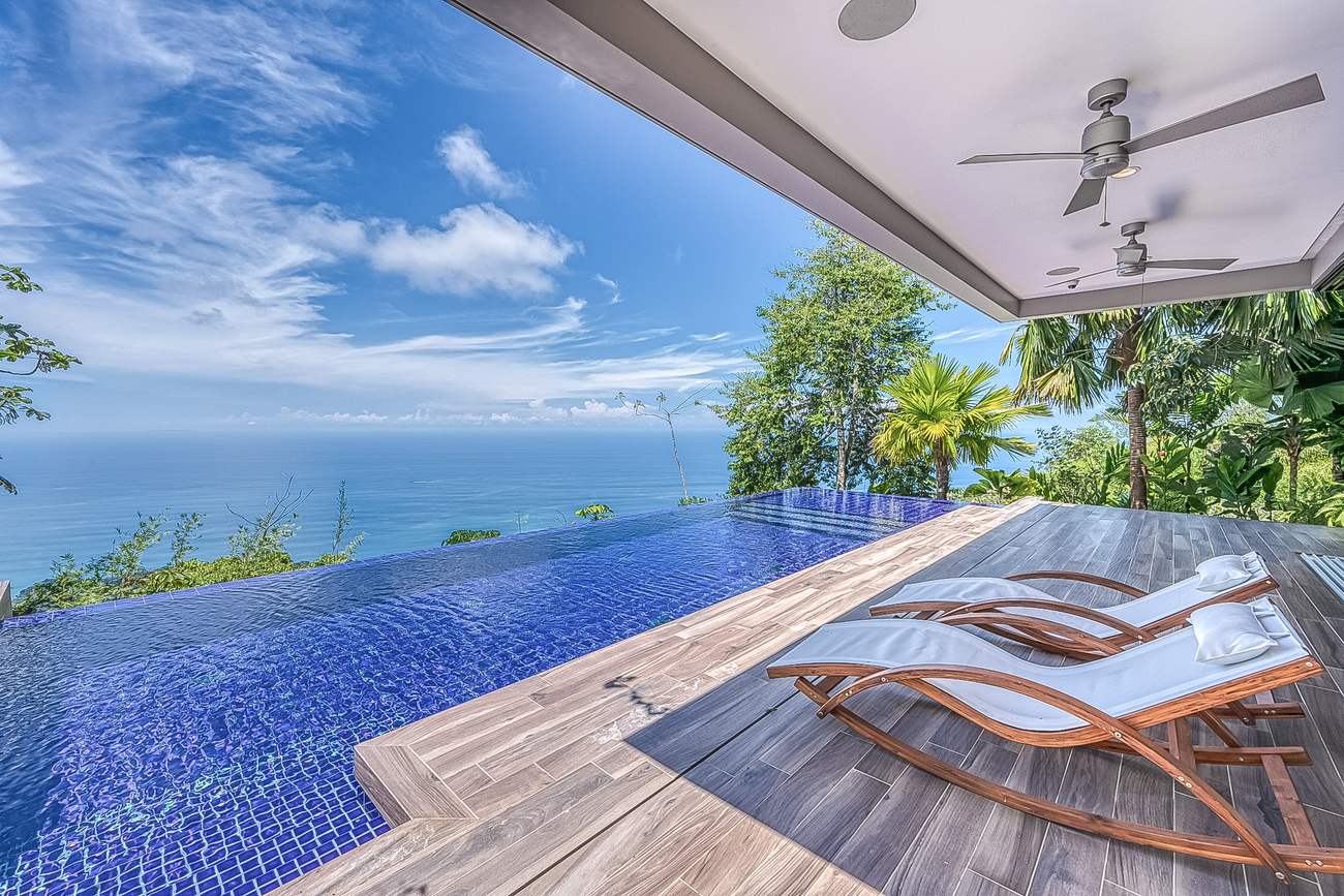 The deck and pool from a lounger at the water's edge