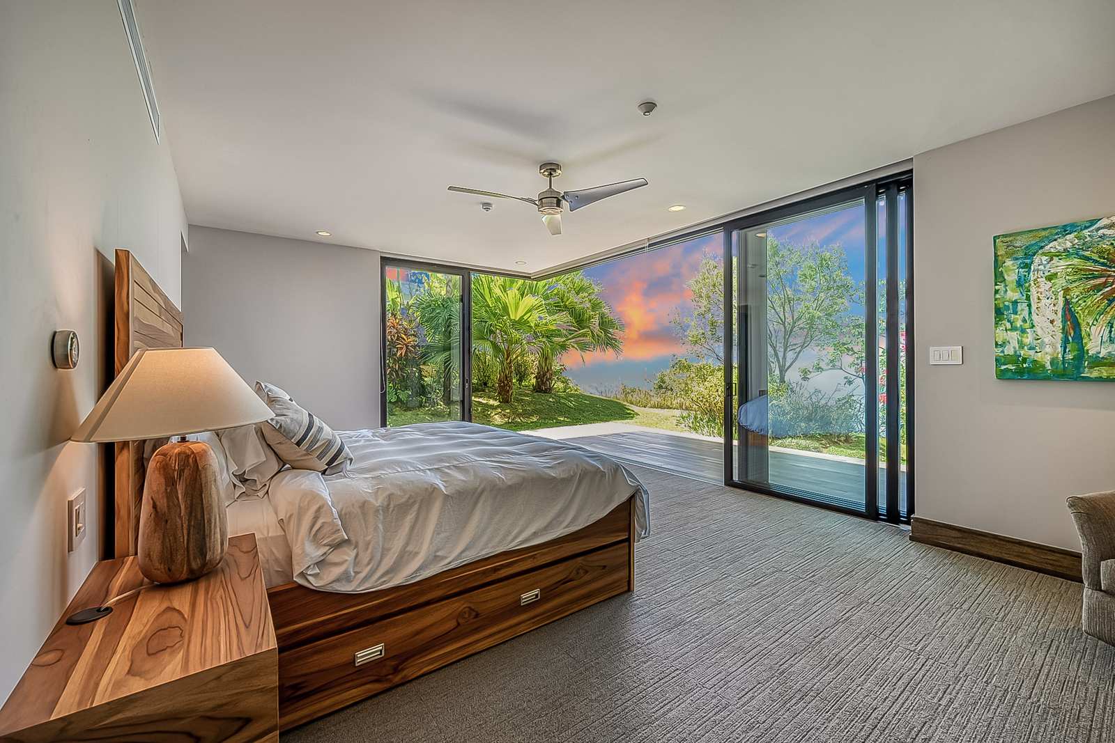 A bedroom at sunset, glazed to the ocean