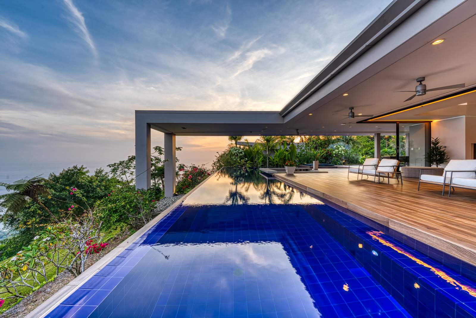 The pool lit at night, above the coastline