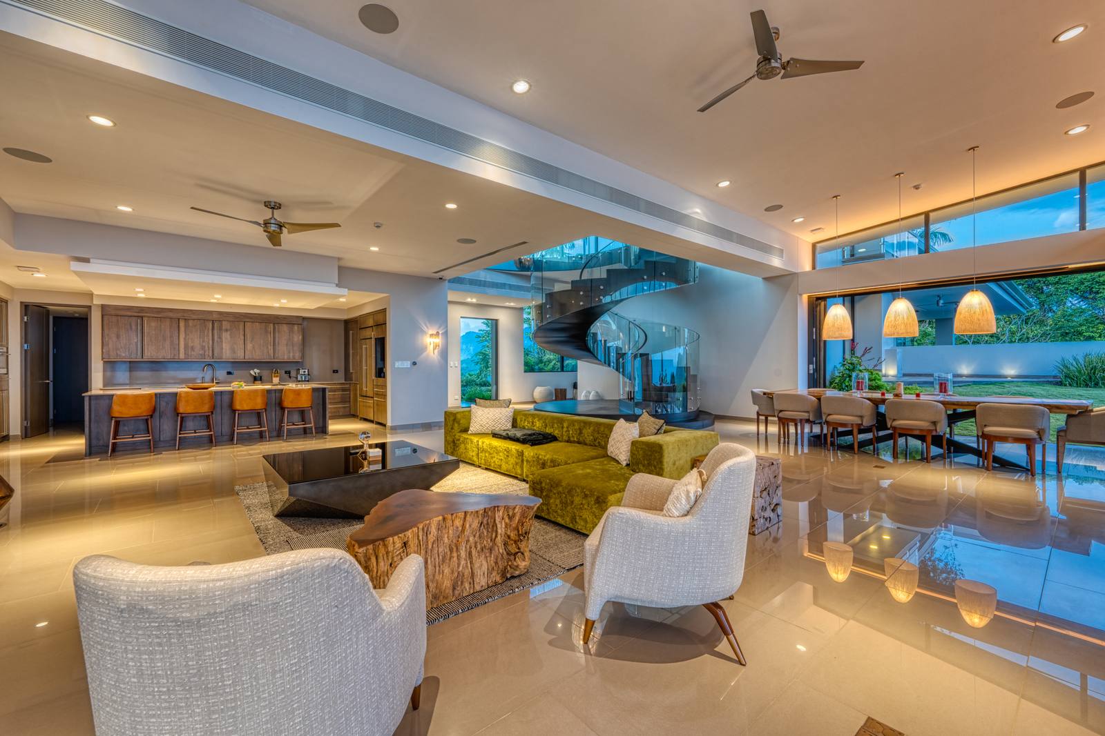 The living room and spiral staircase at dusk