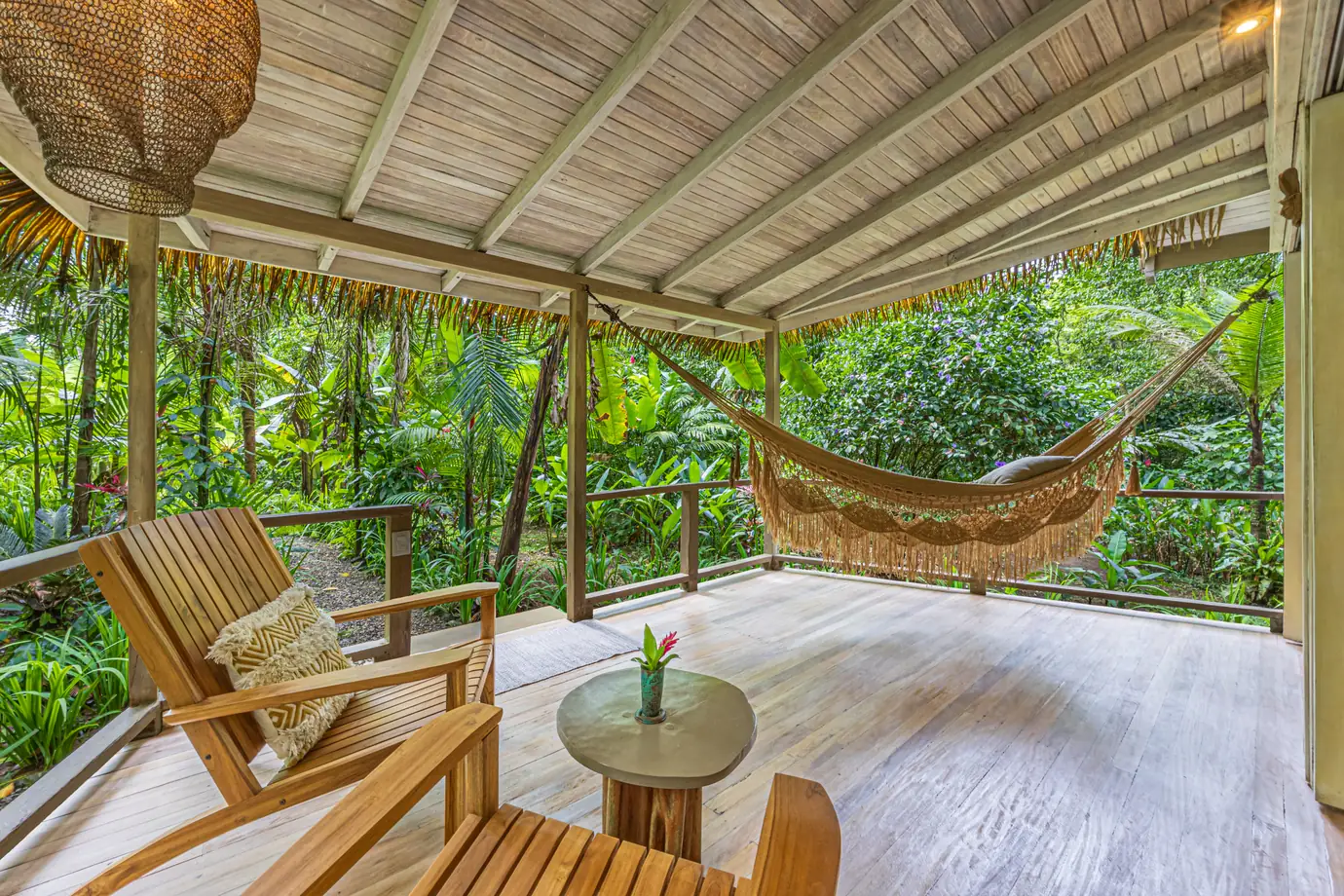 680-acre Golfo Dulce estate &mdash; A covered deck with hammock and chairs facing the forest