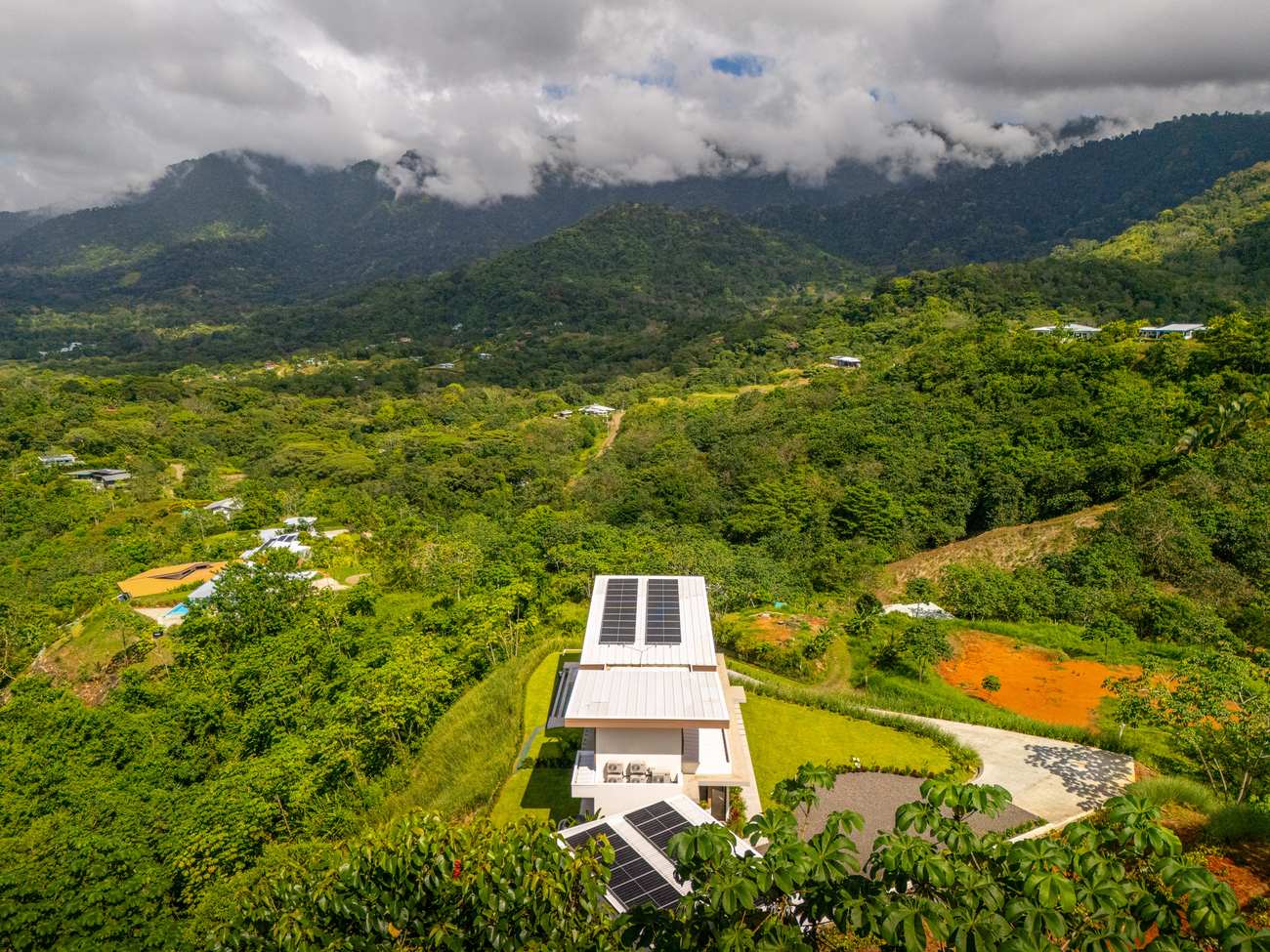 Modern Glass Estate &mdash; From the air, with the 300-degree mountain backdrop behind