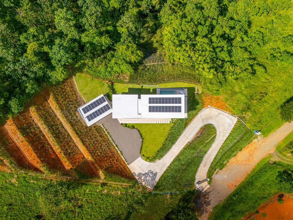 Modern Glass Estate &mdash; The 36-panel solar array on the roof