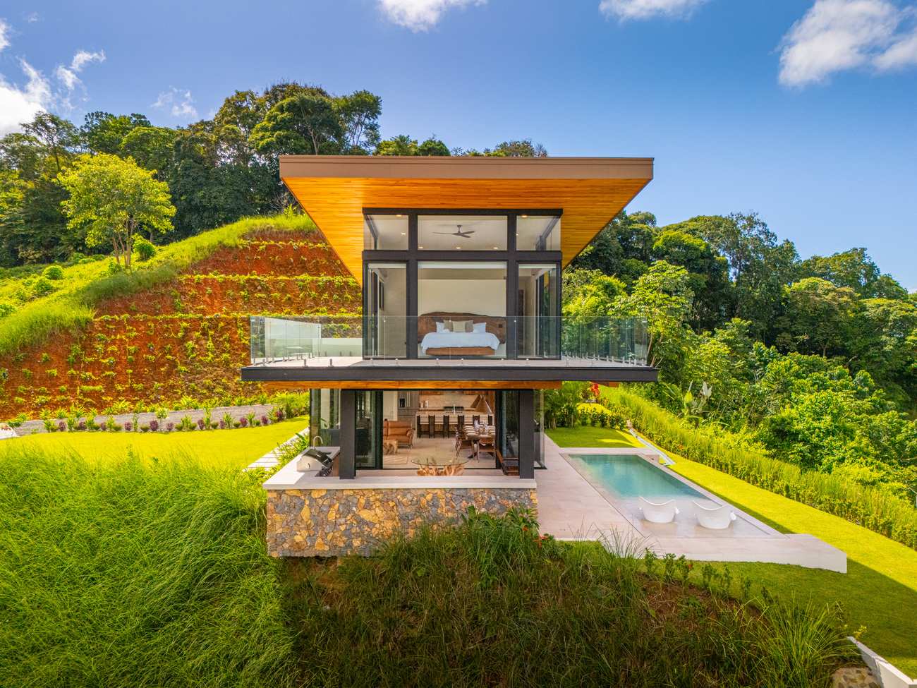 Modern Glass Estate &mdash; The pool alongside the glass living pavilion