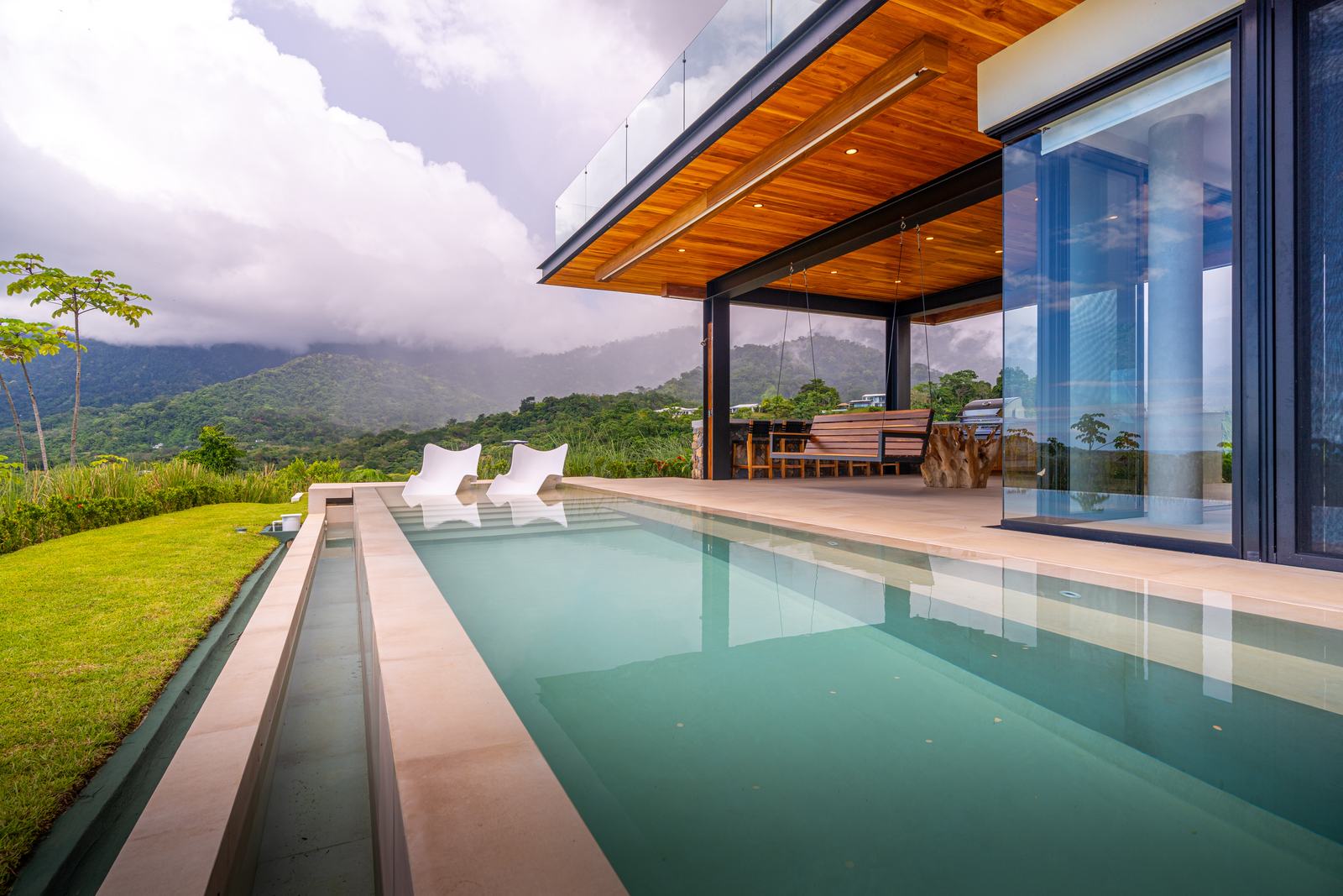 Modern Glass Estate &mdash; Loungers on the pool terrace