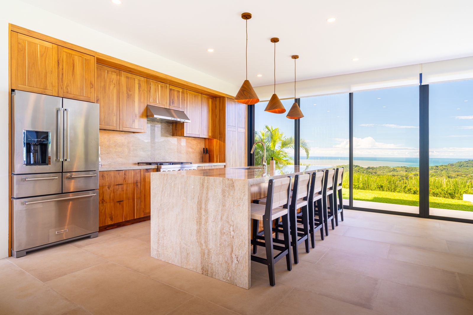 Modern Glass Estate &mdash; The kitchen in teak and quartzite