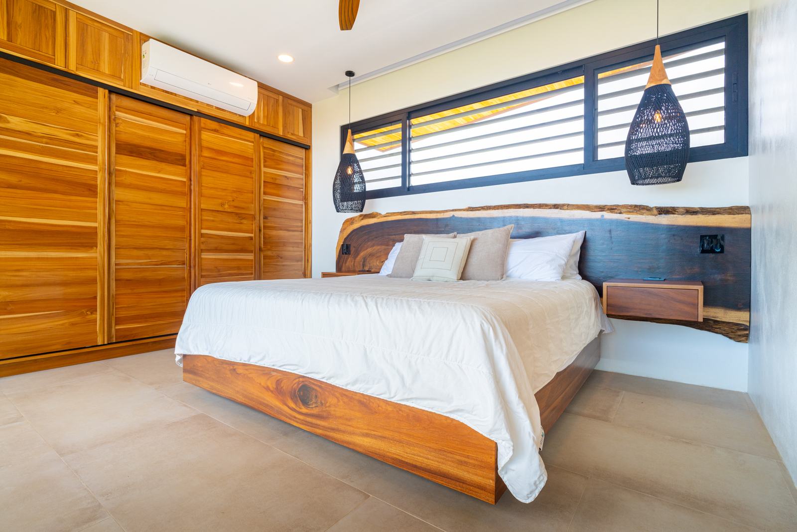 Modern Glass Estate &mdash; A bedroom opening onto the terrace