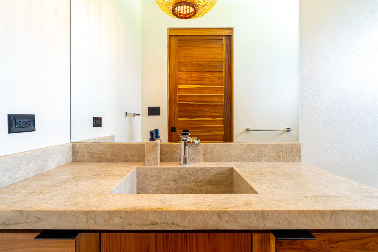 Modern Glass Estate &mdash; A vanity in solid teak, with Hansgrohe fittings