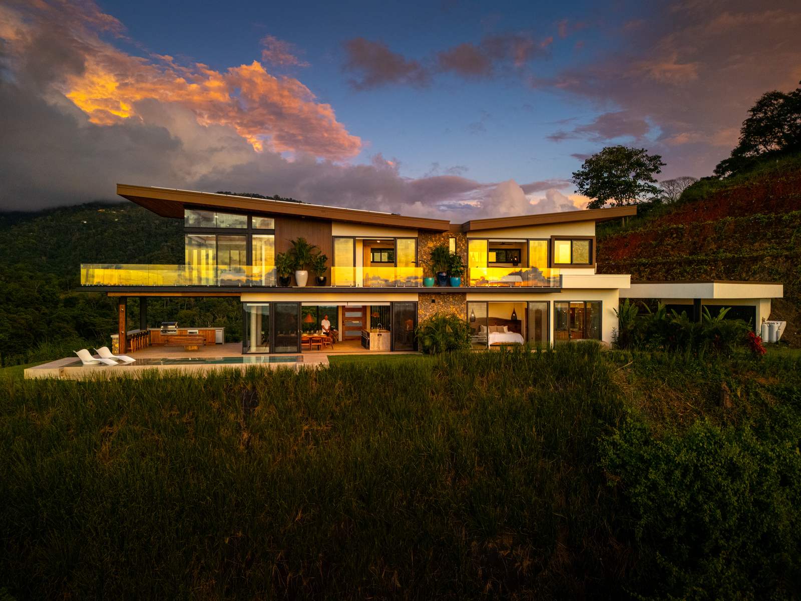 Modern Glass Estate &mdash; The house at night, seen from the drive
