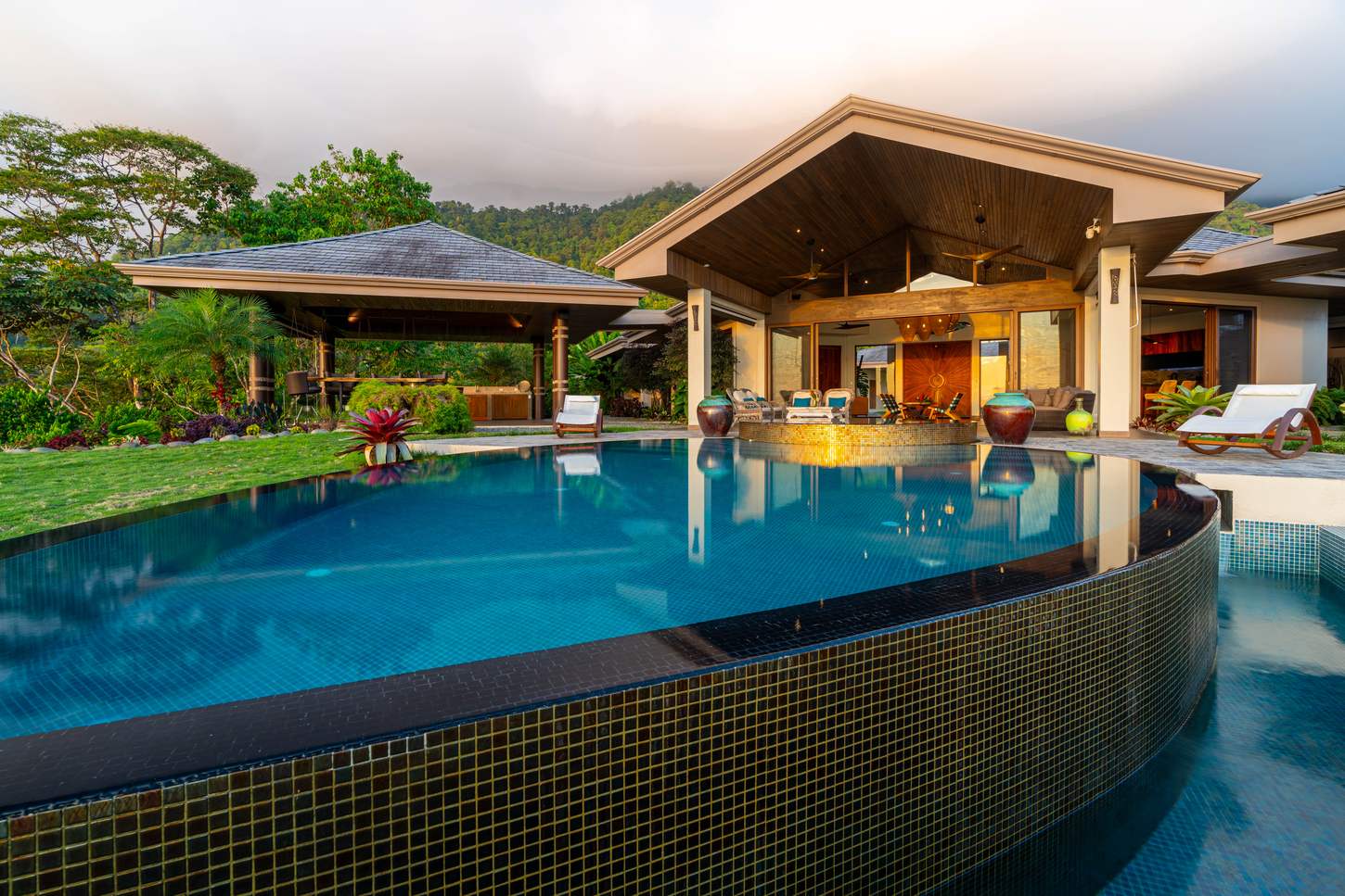 Sue&ntilde;o del Pac&iacute;fico &mdash; The pool at dusk, the pavilion lit behind