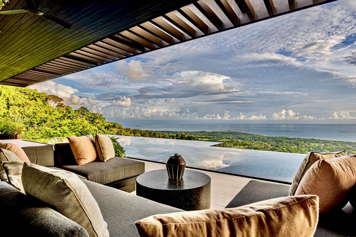 Uvita Black House — the terrace lounge, open to the coastline and the sunset line