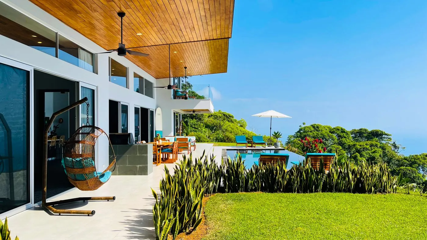 Villa Oro Verde &mdash; the covered terrace opening onto the lawn