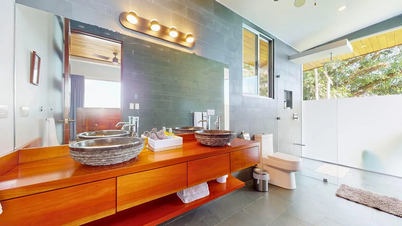 Villa Oro Verde &mdash; an ensuite bath with twin stone vessel sinks