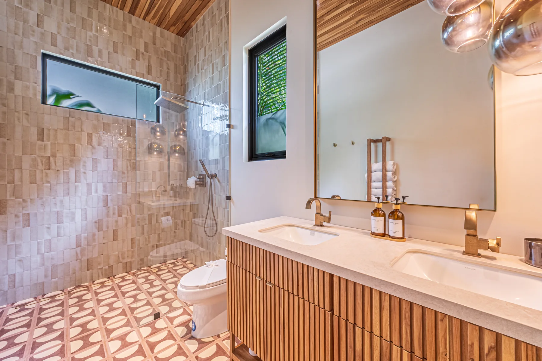 Villa San Martin &mdash; the primary bath, dual vanity and walk-in shower