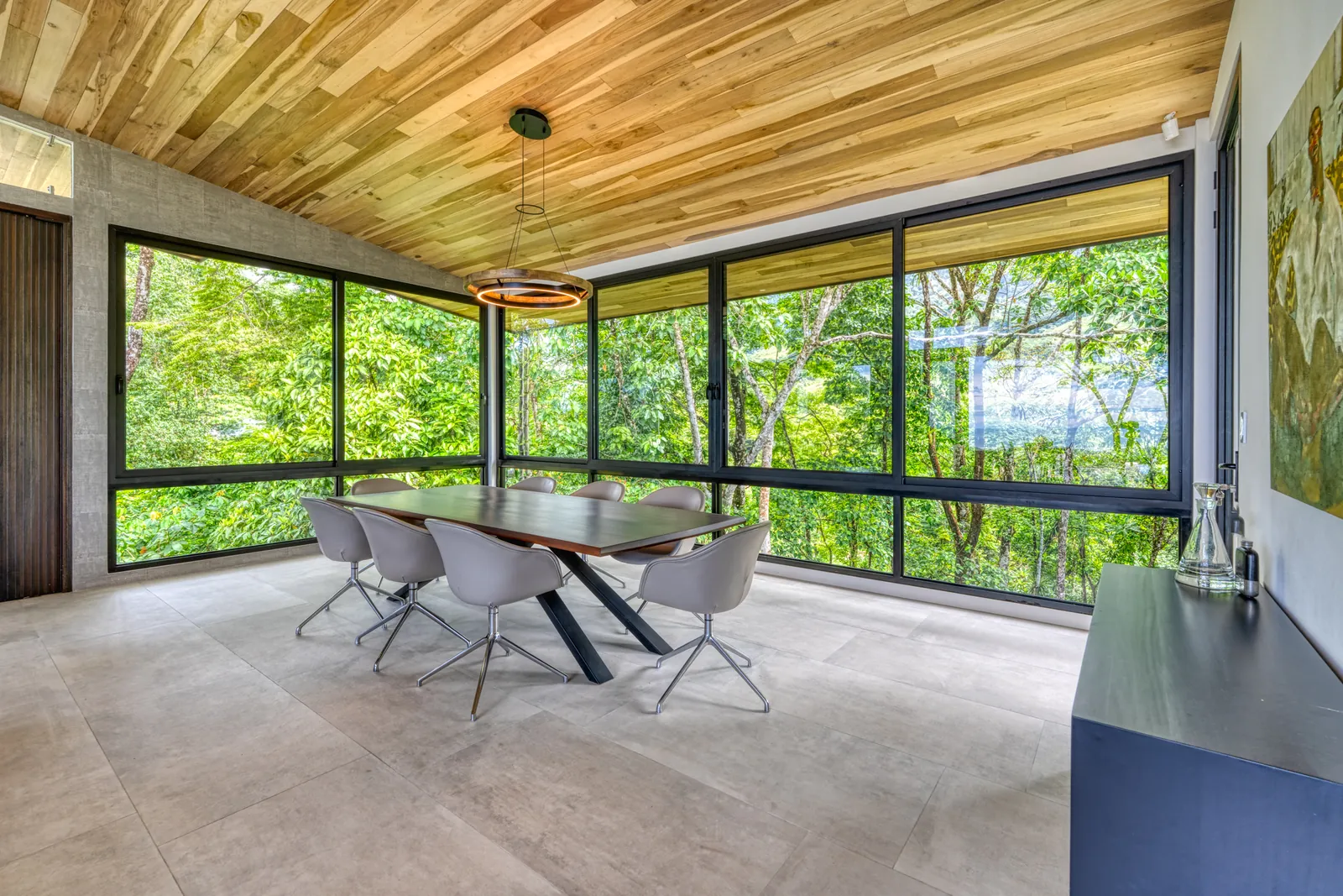 Vista Hermosa &mdash; the dining room, glazed on two sides into the trees