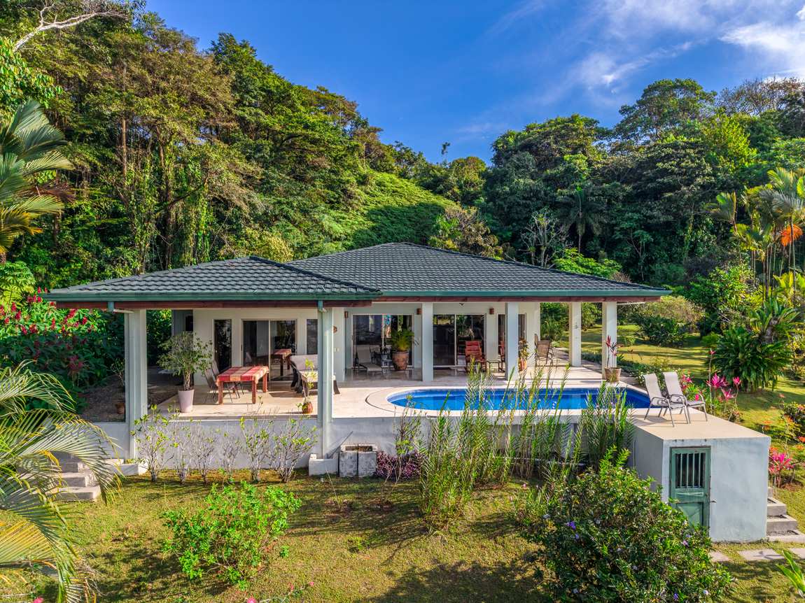 The house and pool from the air, set in 9.44 acres inside Costa Verde Estates