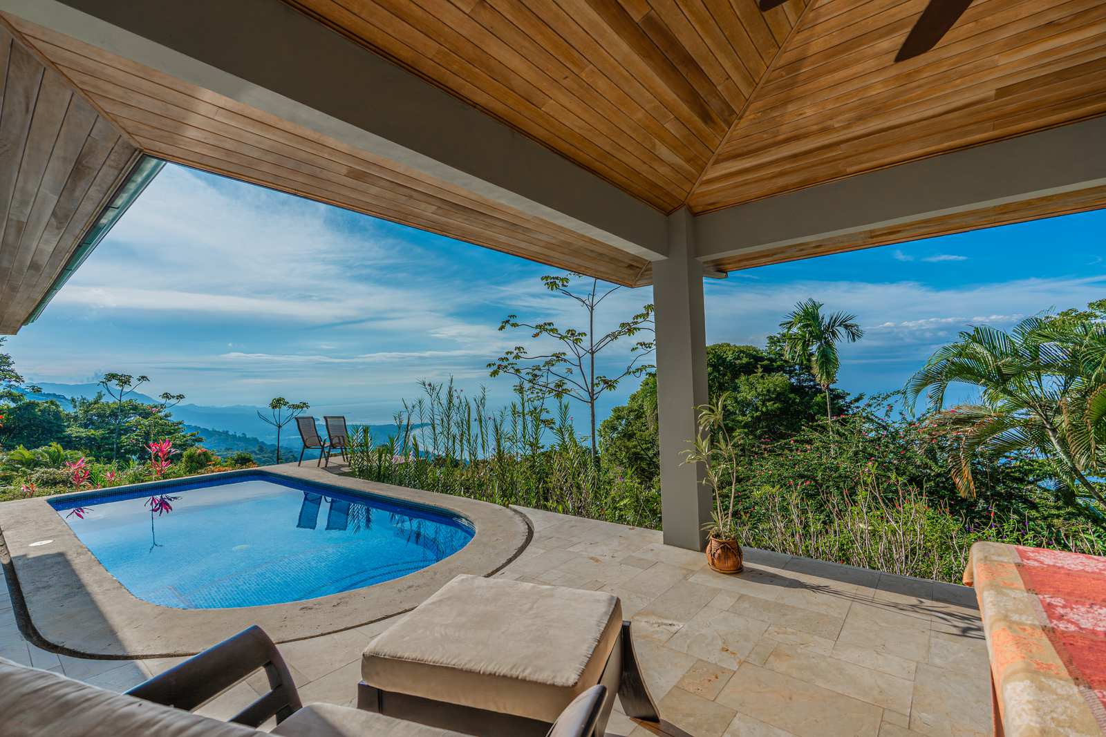 Loungers on the pool terrace facing the view