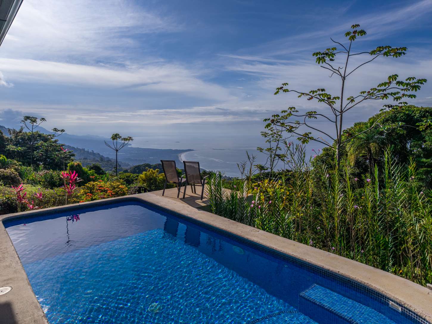 The pool under an open sky, with the coast beyond