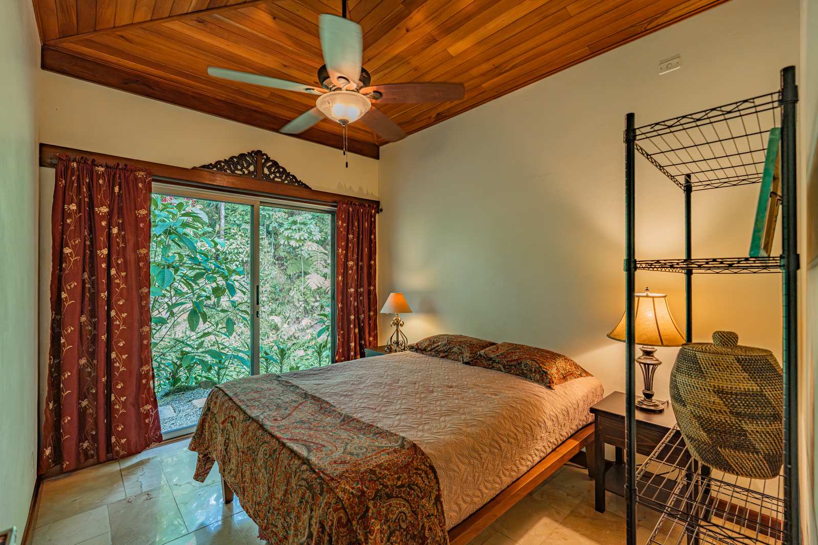A guest bedroom looking into the forest